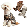 A fluffy white dog wearing a leopard print jumpsuit and matching paw boots.