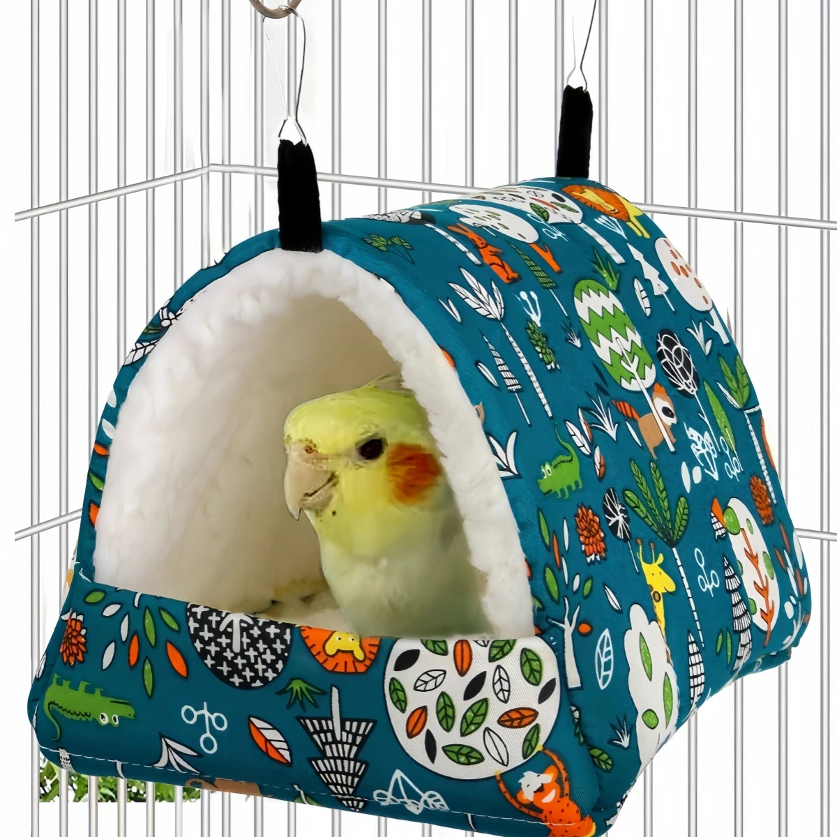 A blue and white patterned cozy bird nest hammock for small pets hanging in a wire cage.