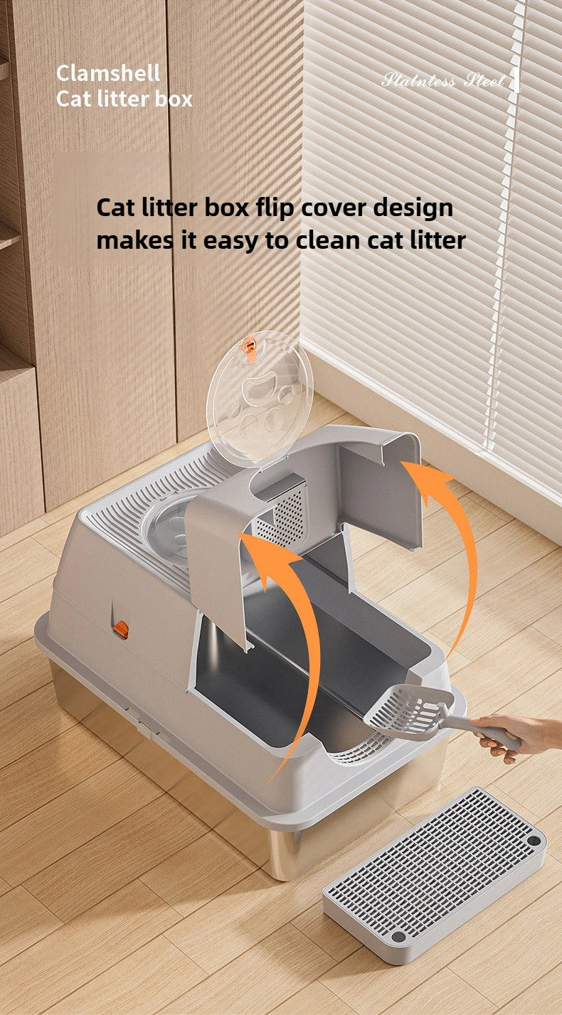 A stainless steel cat litter box with a flip cover design is shown being cleaned with a brush.