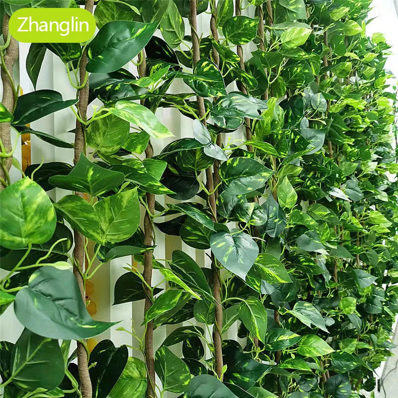 Artificial green vine wall hanging decor featuring lush green leaves climbing a vertical structure.
