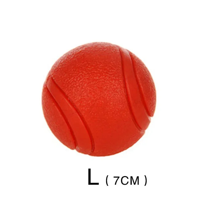A bright red rubber dog ball with segmentation lines, labeled as size L (7cm).