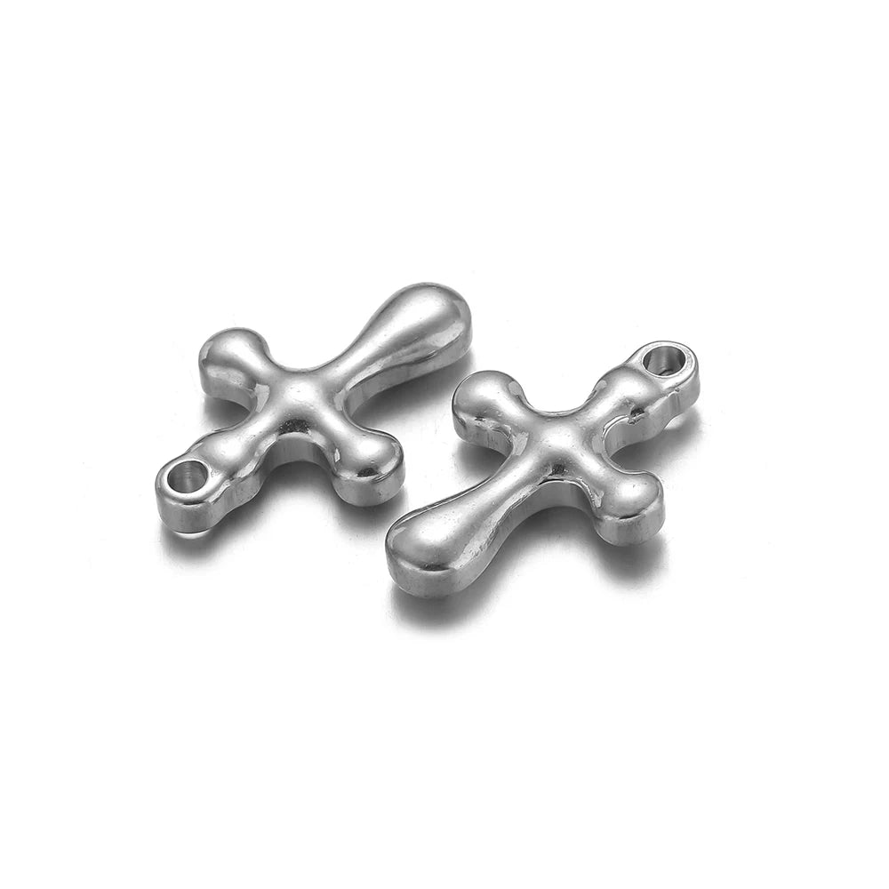 A pair of silver vintage cross charms used for DIY jewelry making.