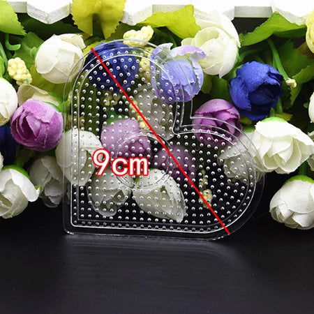 A set of precision hama beads tweezers with various colored beads displayed among fresh flowers.