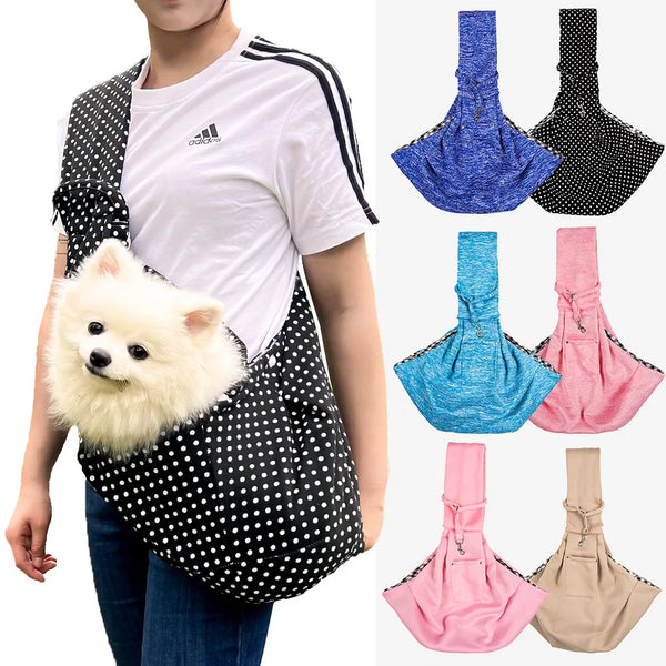 A person wearing a black and white polka dot sling carrier for a small dog, showing the adjustable strap design.