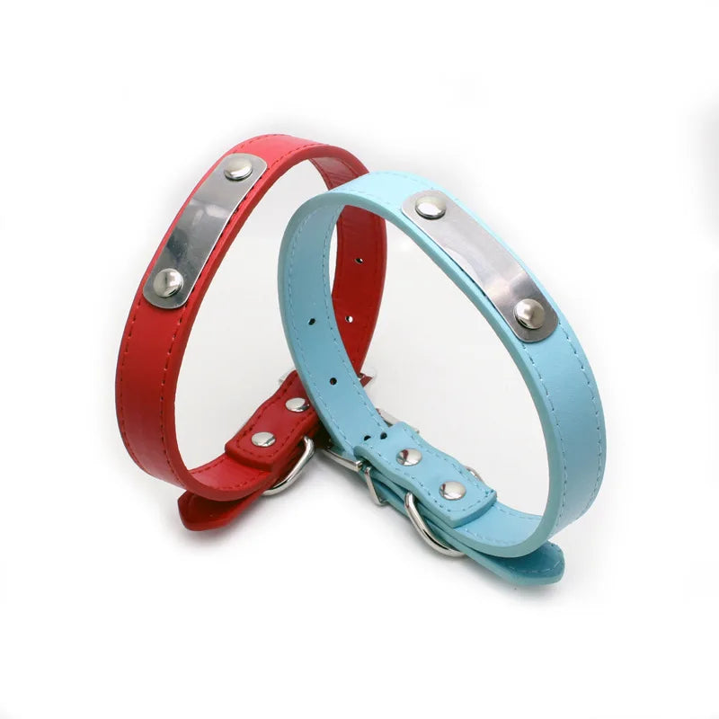 A pair of personalized PU leather dog collars in red and light blue with silver hardware.