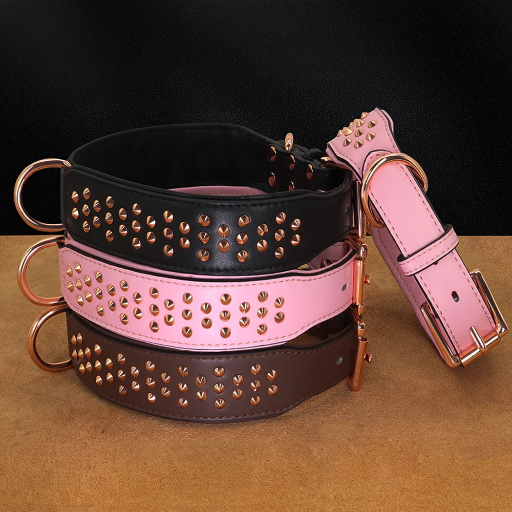 Three stacked adjustable leather dog collars in black, pink, and brown with metal spikes.