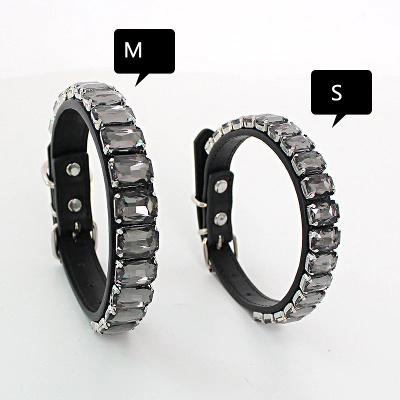 A pair of glittering rhinestone dog collars featuring crystal accents, shown with labels M and S.