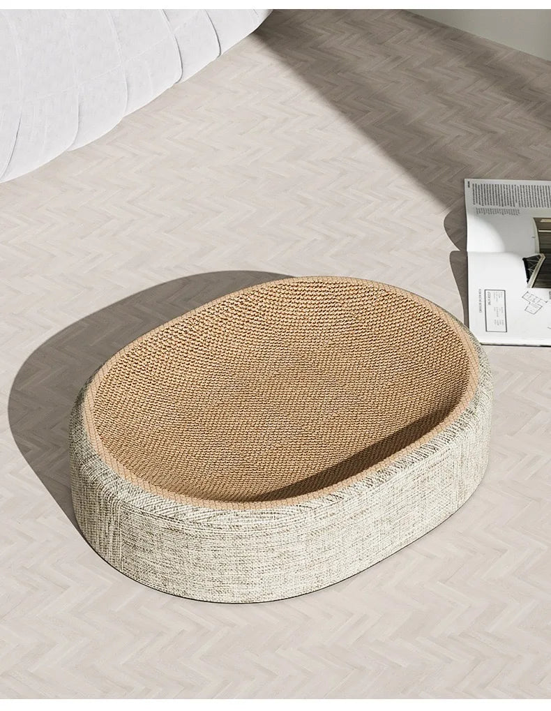 Oval sisal cat scratching board with a resting nest made of natural woven fibers.