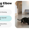 A woman gently applies an Allroaring Dog Elbow Brace Protector to a dog's front leg.
