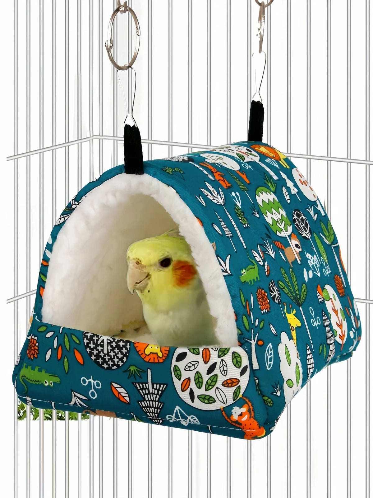 A cozy bird nest hammock for small pets, featuring a blue fabric with various natural patterns and a soft white interior.