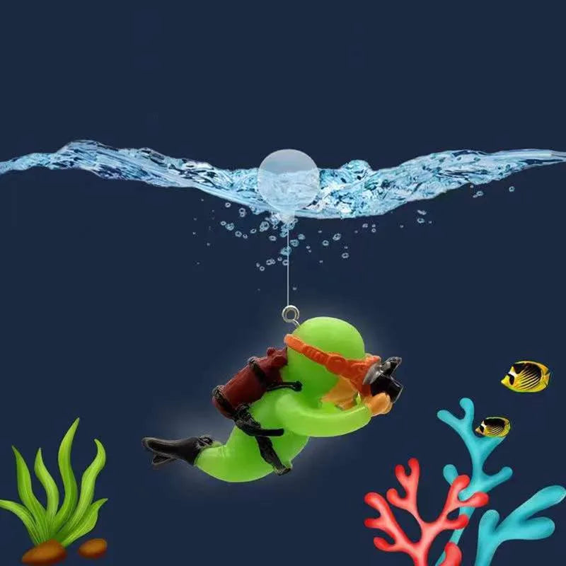 A green resin mini diver ornament is shown diving through water droplets against a dark blue background.