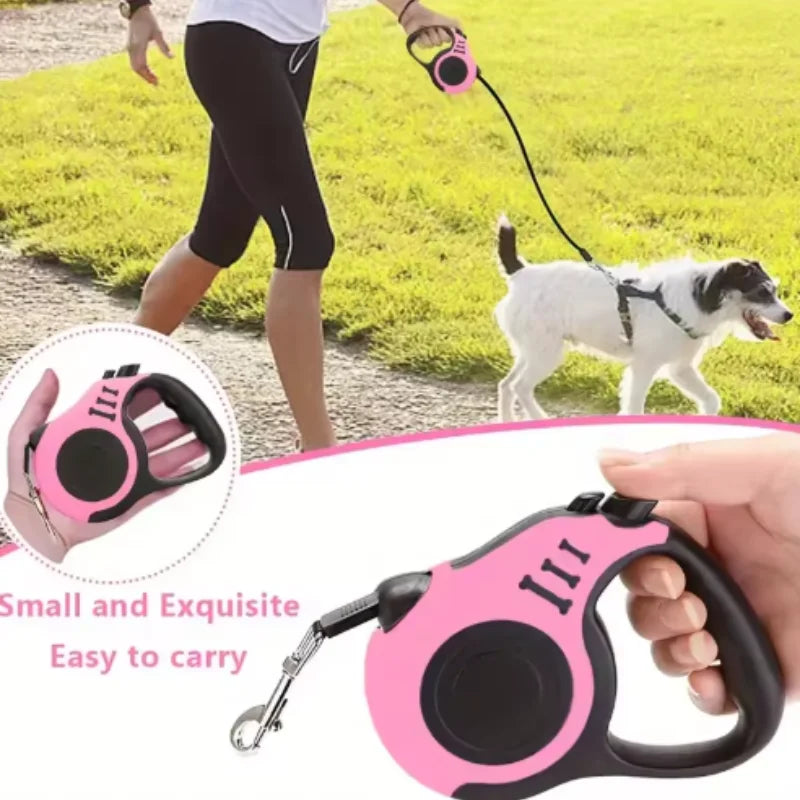 A pink automatic retractable dog leash is shown being used by a person with a small white dog in a grassy outdoor setting.
