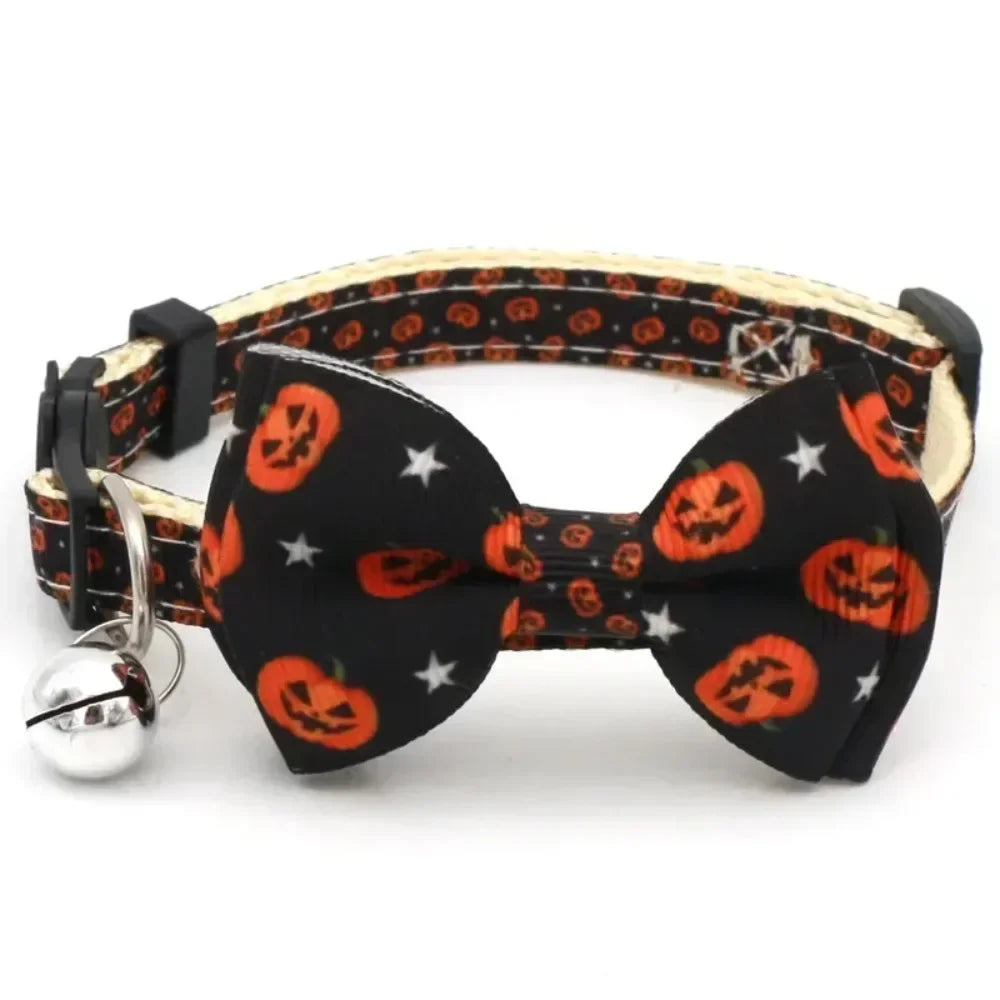 Black Halloween cat collar with an orange pumpkin bow tie and a silver bell.