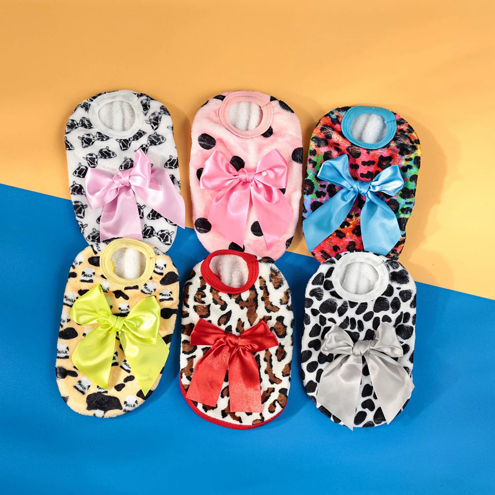 A collection of warm knit pet sweaters for small dogs and cats in various pink, floral, and patterned fabrics.
