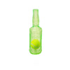A clear glass bottle filled with green liquid, shaped like a dog chew toy with a tennis ball inside.
