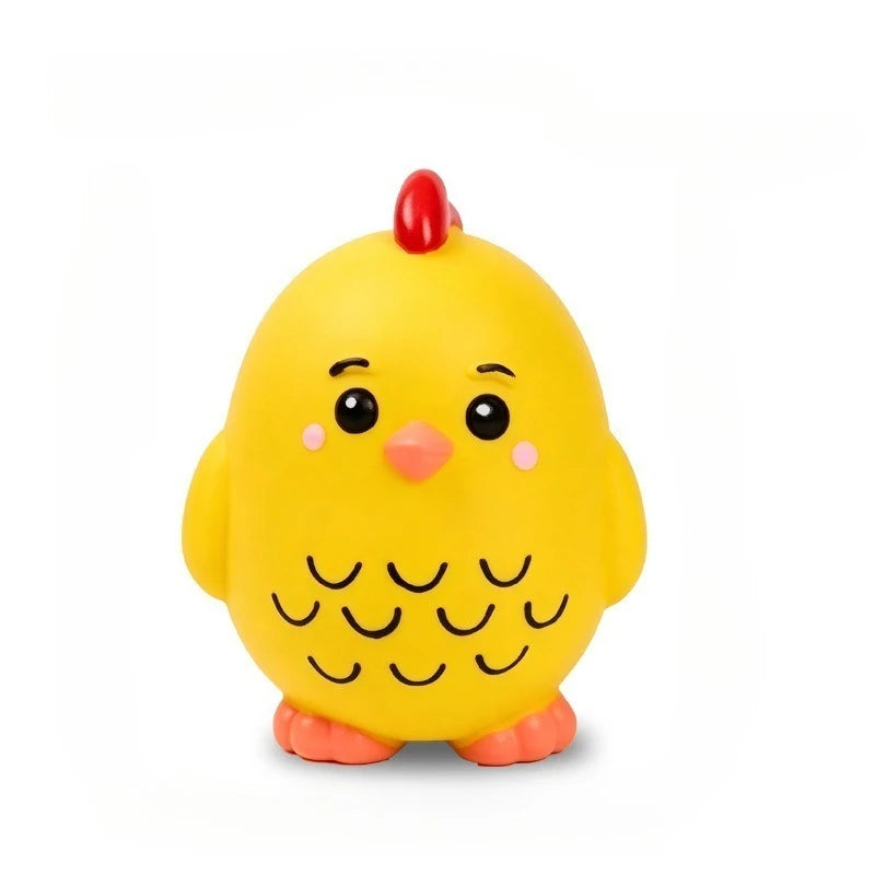 A yellow latex squeaky duck toy with a red beak and small black feathers.