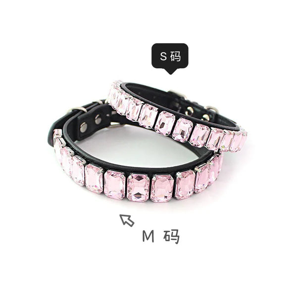A black leather dog collar adorned with pink and clear crystal rhinestones.