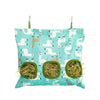 A light blue fabric bag with multiple holes used as a hay feeder for small animals.