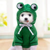 A cute frog-shaped green hoodie with large eyes worn by a small white dog.