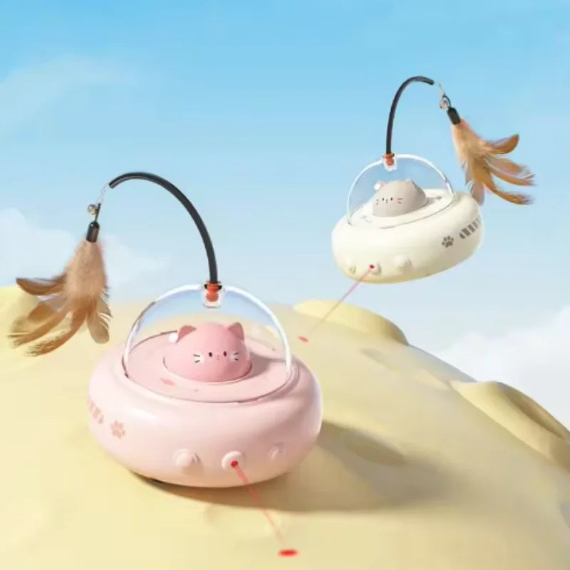 A pink interactive rotating feather cat toy with a small cat figure is shown against a light blue sky background.