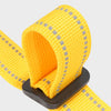 A close-up of a yellow adjustable bar buckle dog harness strap with reflective accents.