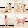 A light tan dog wearing a cozy pink fleece jumpsuit for small and medium breeds.