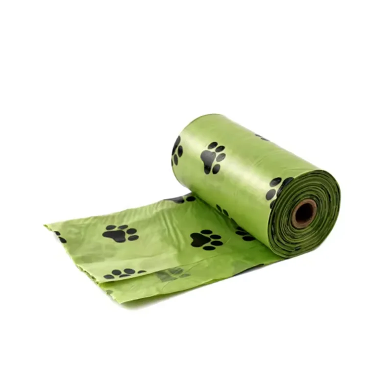 Roll of green dog poop bags with black paw prints