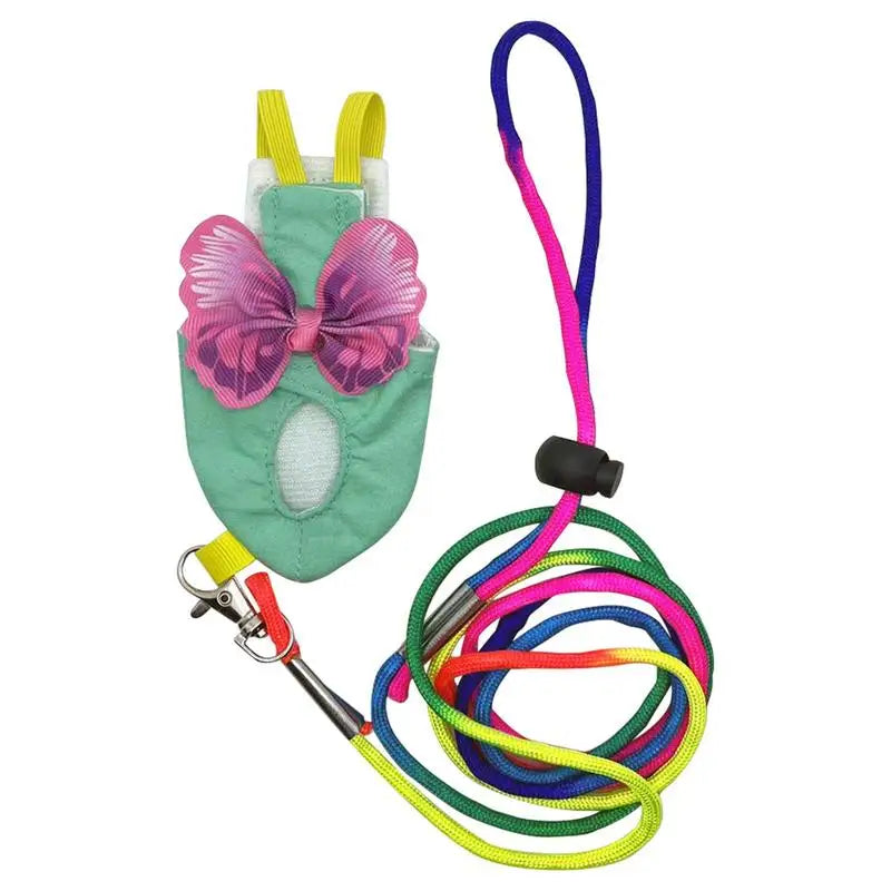 A soft reusable parrot flight suit with pink and purple straps and a green body.