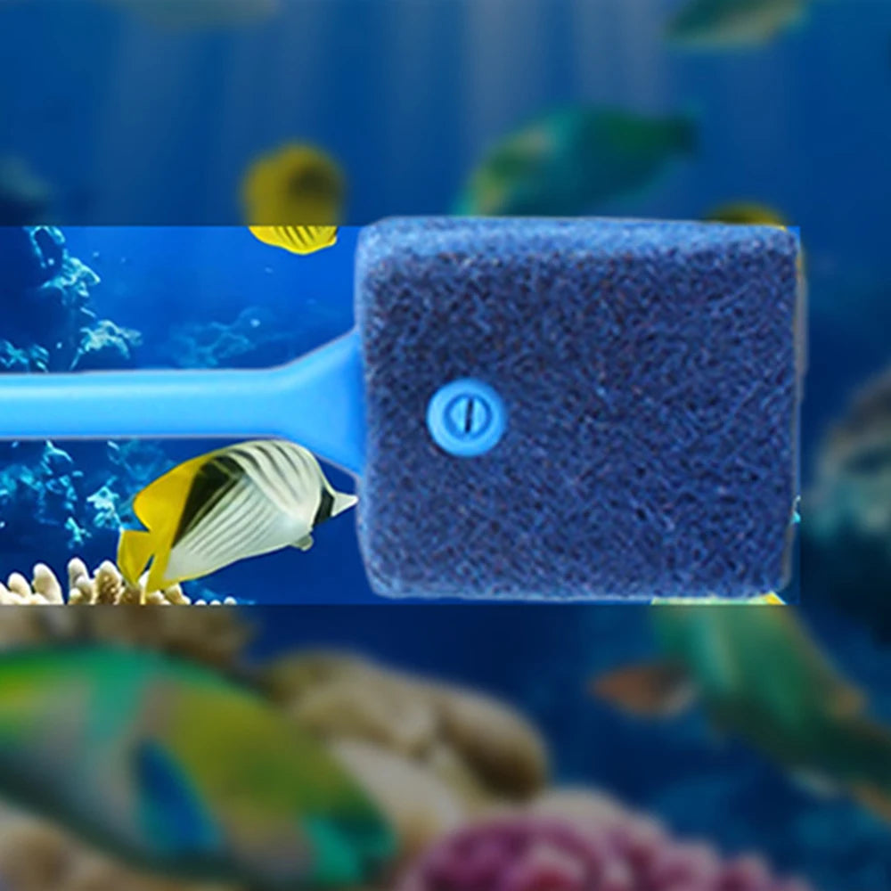 A blue cleaning brush with a purple sponge is shown in an underwater aquarium setting.