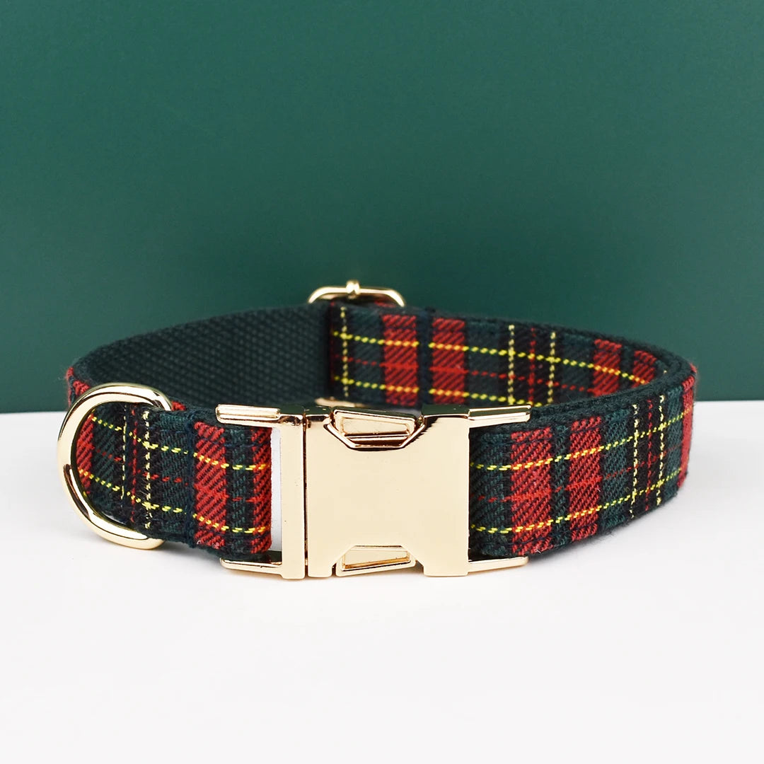 A personalized plaid dog collar featuring red, black, and yellow tartan fabric with a gold-toned buckle.
