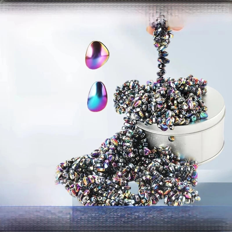 A pile of colorful, iridescent stone cobblestone beads and several polished stones are displayed against a light background.