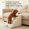 A brown dog is climbing a beige pet safety ladder designed for pets to climb on slopes.