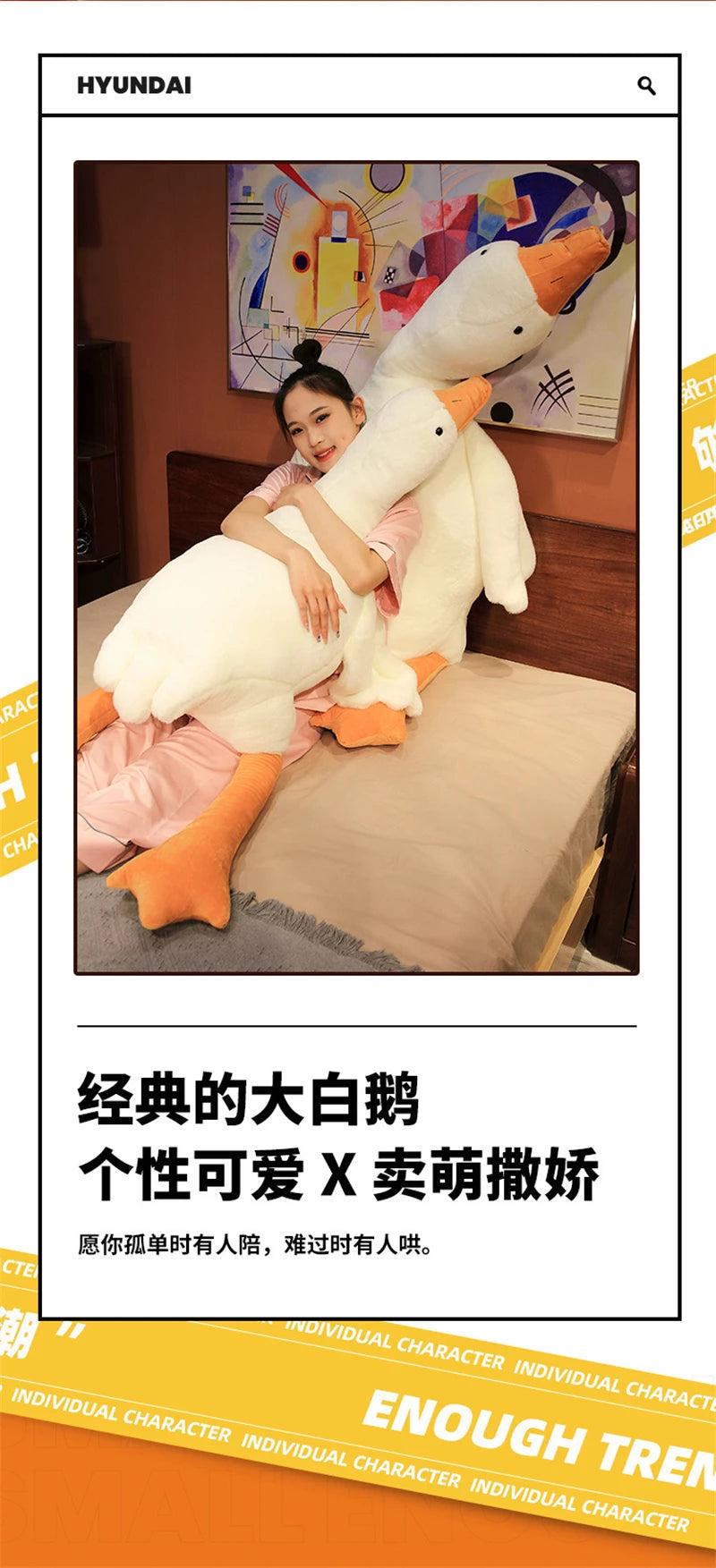 A woman is cuddling a large white plush goose body pillow in a bedroom setting.