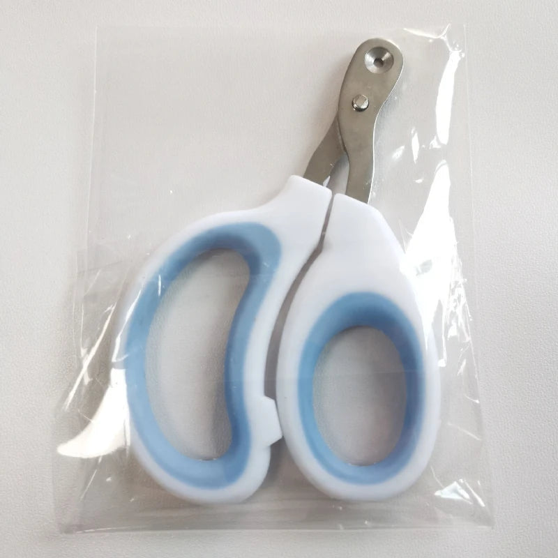 A pair of white adjustable pet nail clippers with light blue accents are sealed in a clear plastic bag.