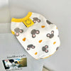 A white pet vest with a cartoon print of gray and orange rabbits on a light gray background.