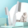 A white stainless steel pet grooming comb set with a wide-toothed comb is displayed on a light blue surface.