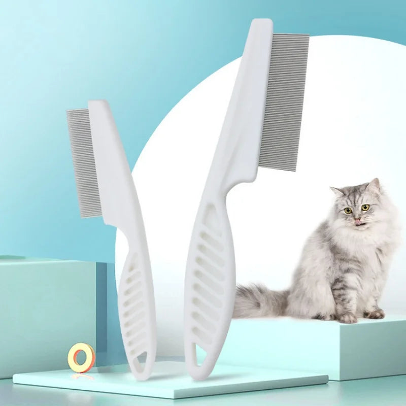 A white stainless steel pet grooming comb set with a wide-toothed comb is displayed on a light blue surface.