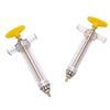 A yellow parrot feeding syringe with a clear plastic hose and a metal tip.