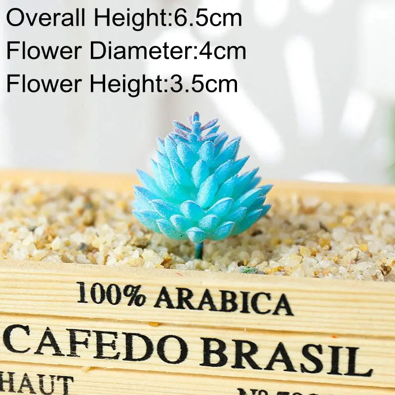 Blue artificial succulent plant with a conical shape growing in sand on a wooden surface