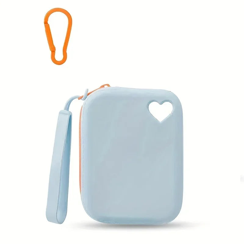 Light blue silicone dog treat pouch with an orange loop attached