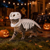 A tabby cat wearing a white dinosaur skeleton costume walking on grass in an outdoor setting.