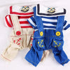 A blue and white seaman dog Halloween costume jumpsuit with a white collar and red stripes.