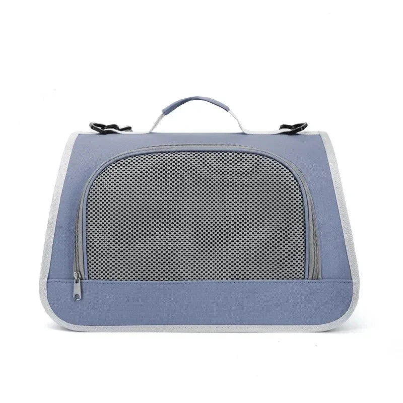 A light blue breathable pet carrier bag for cats and small dogs with a mesh front and carrying handles.