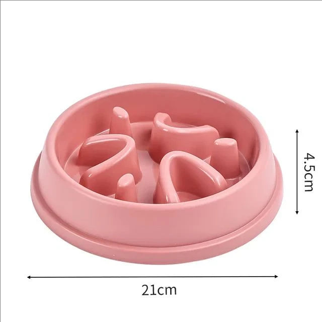 A pink anti-choking slow feeder bowl for dogs and cats with ridges, shown from above.