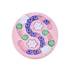 A pink interactive puzzle slow feeder bowl with various colored silicone puzzle pieces for pets.
