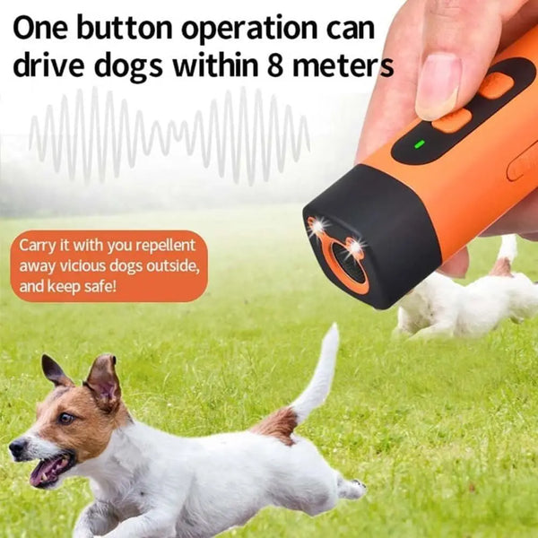 A hand holds an orange ultrasonic dog bark deterrent device while a dog runs in a grassy field.
