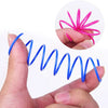 A hand holds a blue spring toy and a pink spring toy, demonstrating the interactive nature of the cat spring toys for play.
