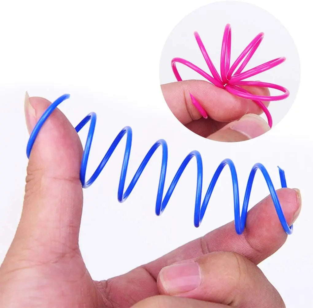 A hand holds a blue spring toy and a pink spring toy, demonstrating the interactive nature of the cat spring toys for play.