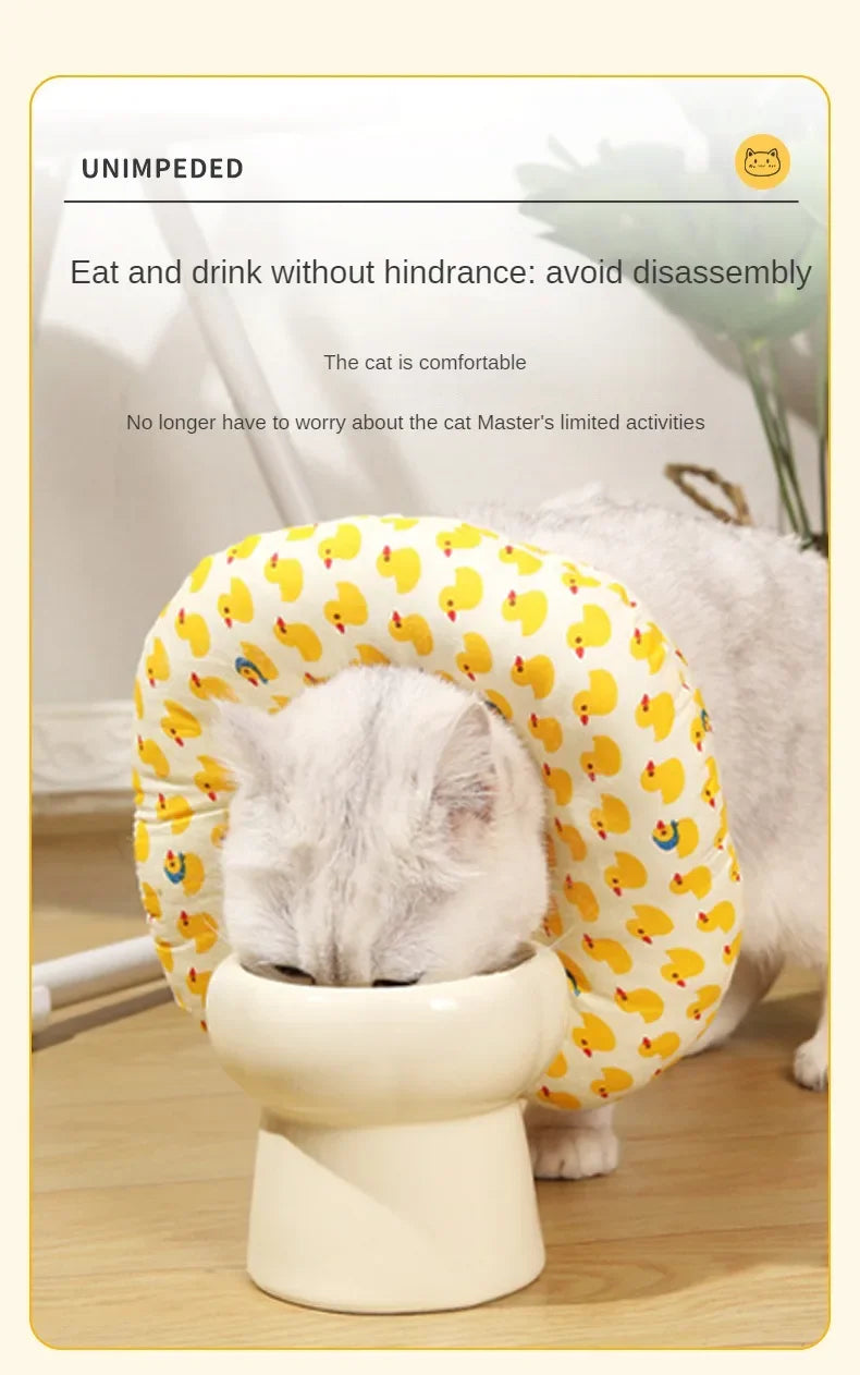 A fluffy white cat is comfortably resting inside a yellow patterned soft cotton recovery collar for dogs and cats.