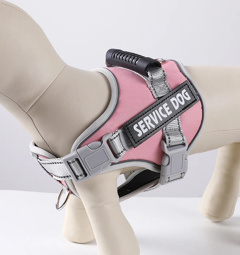A pink and gray reflective dog harness is shown on a white mannequin leg.